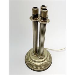 A silver plated table lamp, in the form of three columns upon a reeded circular spreading base with beaded edge, H38.5cm. 