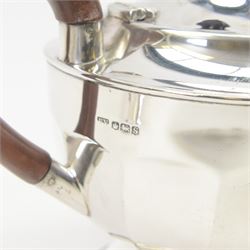 1930s silver three piece tea service, comprising teapot, open sucrier and milk jug, each of circular part fluted form, the jug and teapot with Bakelite type handles, hallmarked Viner's Ltd,  Sheffield 1935