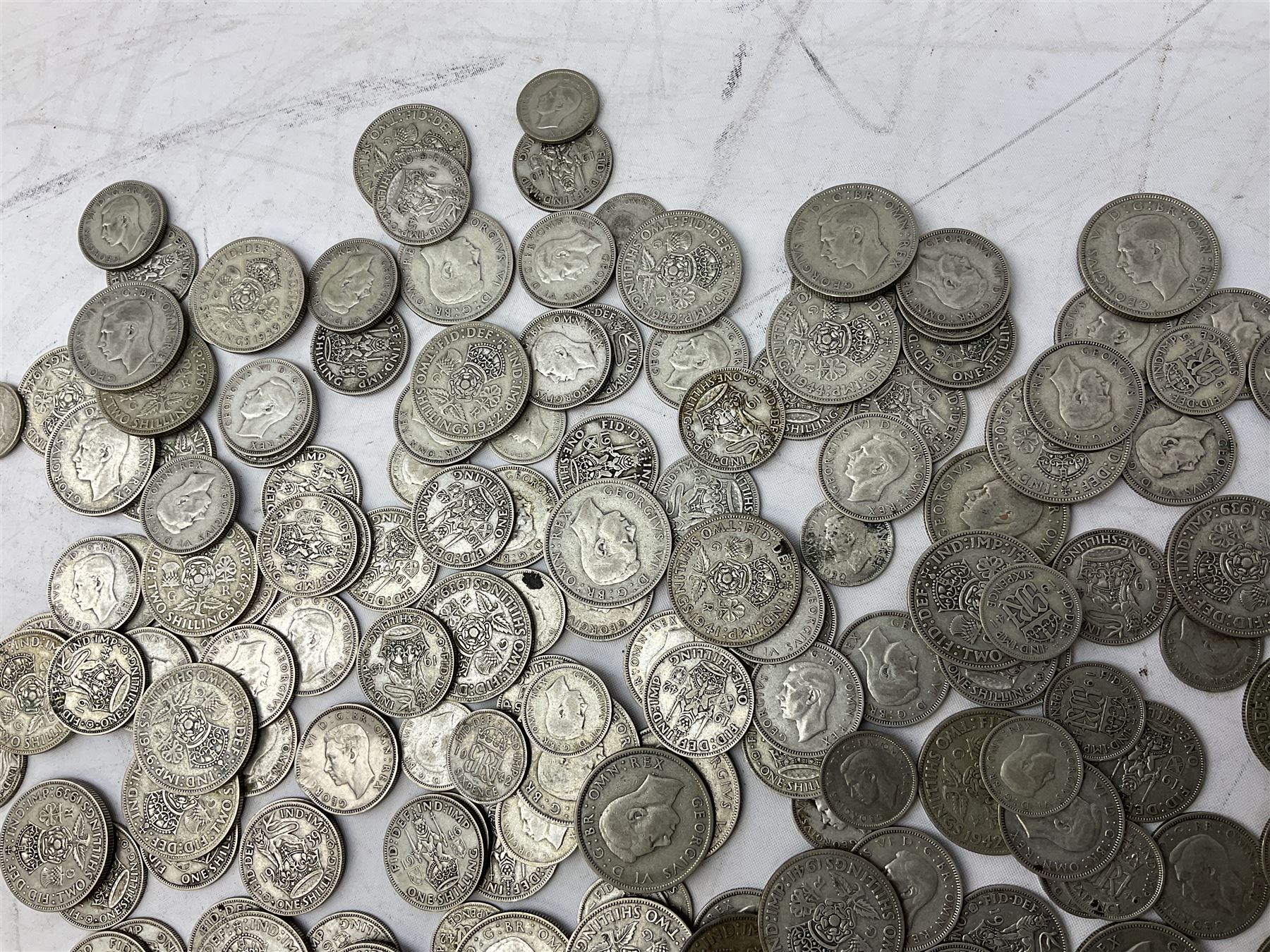Approximately 1460 grams of pre 1947 Great British silver coins, including sixpences, shillings and two shillings 