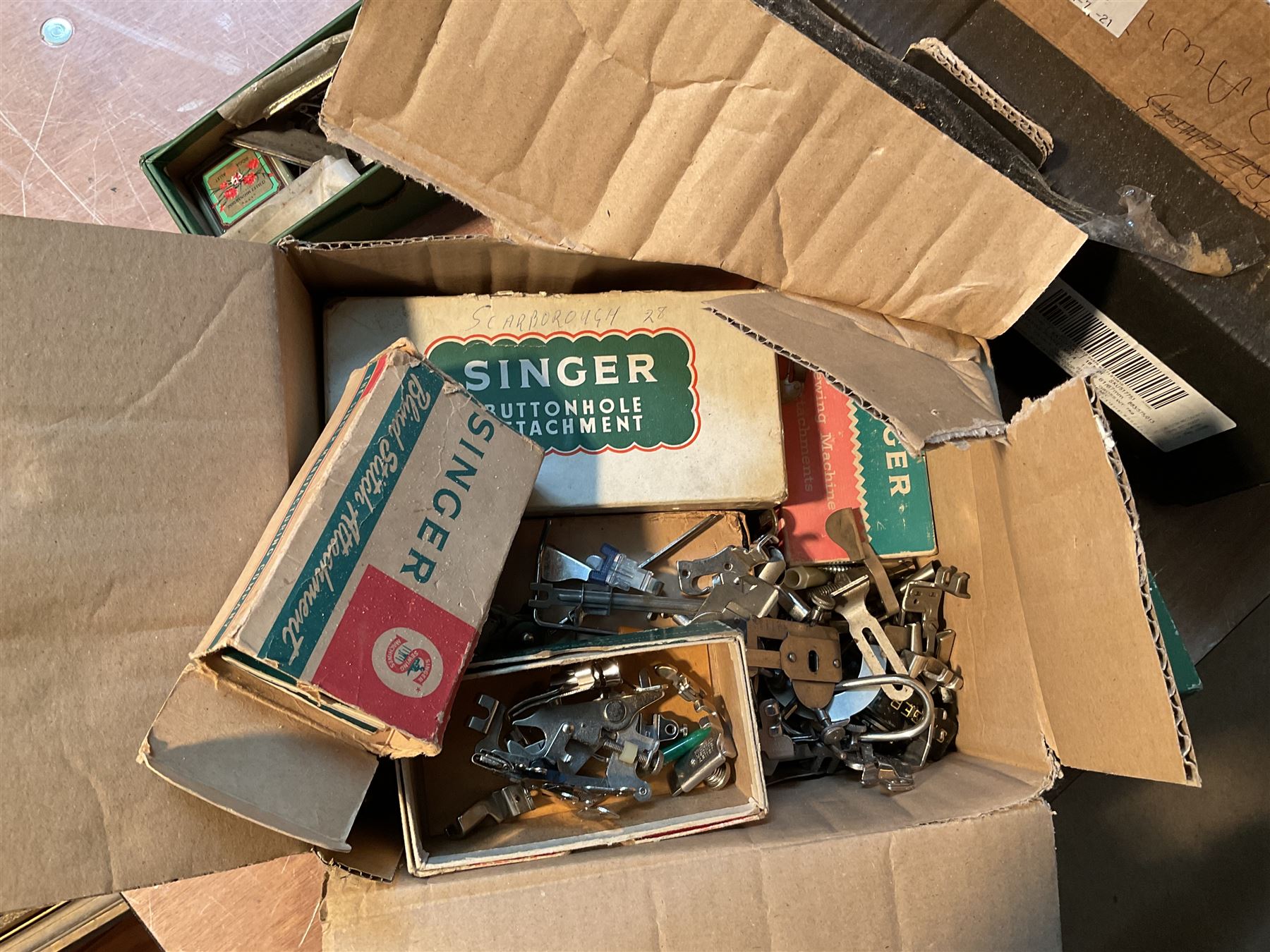 Two Singer sewing machines, model numbers 527 and 457, together with various Singer sewing machine parts, and a selection of sewing related accessories, to include threads, sewing needles, etc.