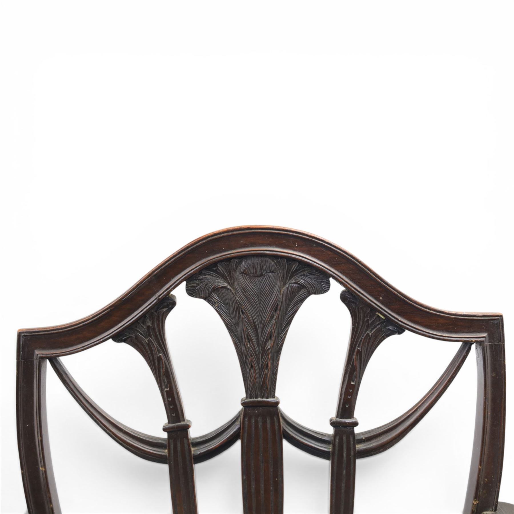 Set of eight George III style mahogany dining chairs, comprising two carvers and six singles, each with shaped top rail above pierced splay carved with feathers, with drop in stuffover seats upholstered in blue striped fabric, raised upon square tapering legs joined by stretchers, together with a mahogany twin pedestal dining table, the oval top with central leaf raised upon turned columns and splayed reeded legs terminating in lion paw feet and brass castors, 