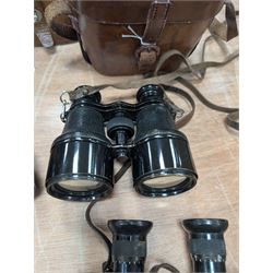 Four pairs of early 20th century binoculars, including Carl Zeiss Jena Feldstecher binoculars, Carl Zeiss Telact 8x binoculars, Dollond x5 field binolculars and one other pair, all in leather cases, one case marked with broad arrow, some with officers name etched