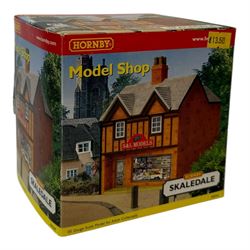 Ten Hornby '00' gauge Skaledale buildings, comprising two R8744 Straight Walls, R8564 Model Shop, R9768 The Pharmacy, R8501 Raven Cottage, R8515 Clovelly Cottage, R8626 Country Fire Station, R8588 Weighbridge & Scales, R8638 Platform & Shelter and R9763 Off Your Head Barbers Shop, all boxed