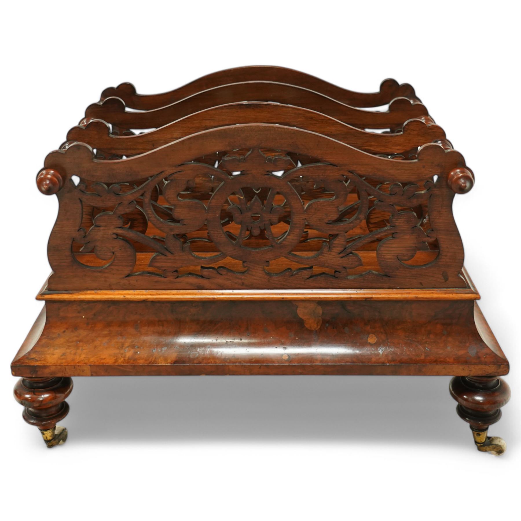  Victorian, walnut Canterbury- magazine rack with four fretwork upstands, drawer to base, standing on turned legs terminating in original castors. circa 1880