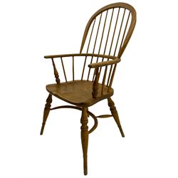 Georgian style light elm Windsor armchair, high comb back, saddle seat, crinoline stretcher base