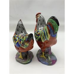 Pair of early 20th century Chinese export porcelain figures, modelled as a cockerel and hen, each with hand painted polychrome plumage, with gilt beaks and detailing, upon a rockwork base, tallest H17cm