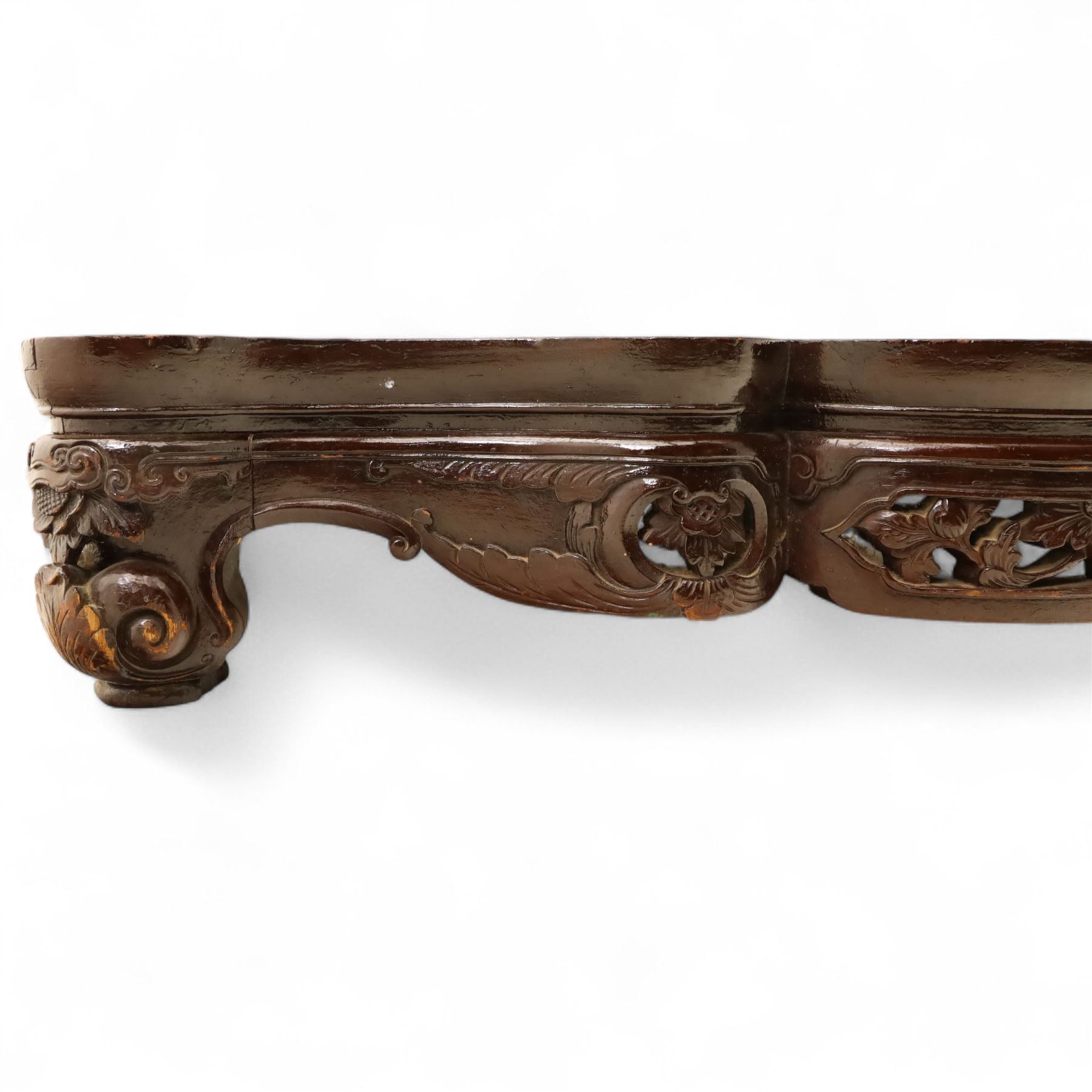 Chinese stained hardwood side table, late Qing dynasty style, with shaped top above a pierced and carved frieze of foliage and fruiting vines, cabriole legs terminating in scroll feet, united by a carved shaped undertier