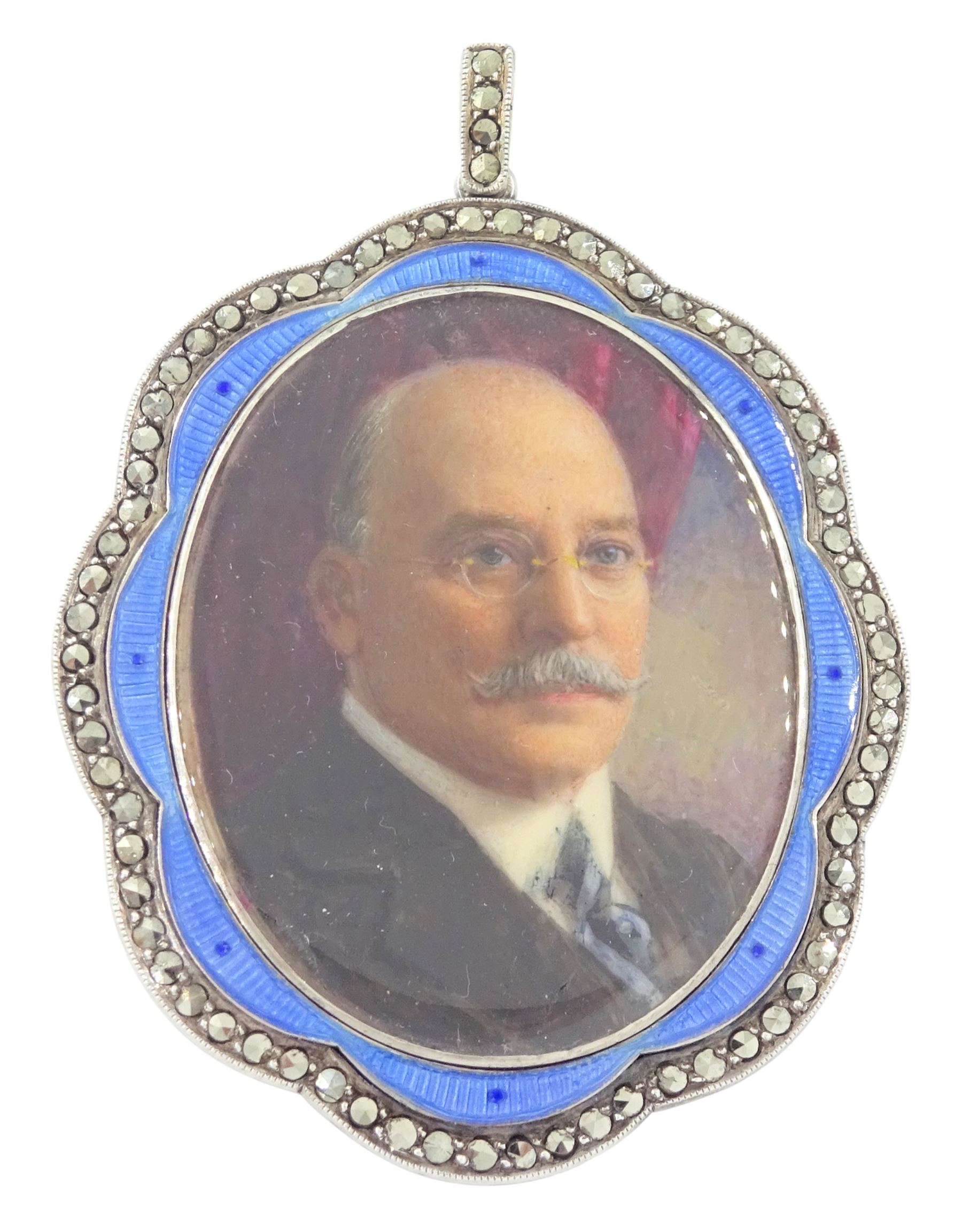 Early 20th century silver guilloche enamel portrait pendant, set with an oval miniature of a gentleman wearing a grey suit on ivory, within a blue enamel and marcasite border, the reverse set with a blue enamel panel and single split pearl, within a silver engraved border, suspended from a marcasite bail

This lot has been registered for sale under Section 10 of the APHA Ivory Act