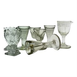 Five 19th century penny lick glasses, together with a pair of 19th century cut glass open salts with lemon squeezer bases, and a 19th century glass measure, largest example H12cm