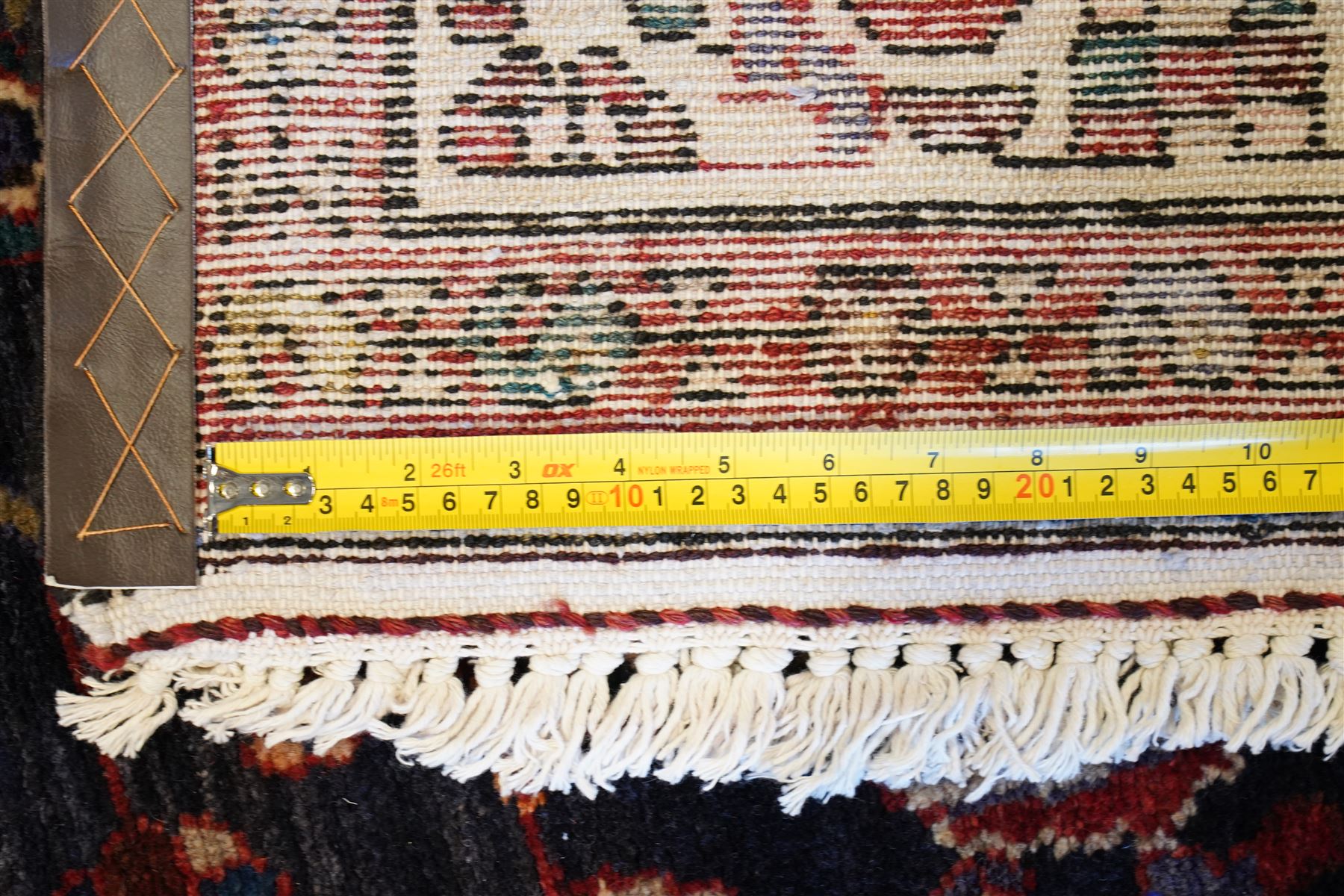 North West Persian Hamadan hand-knotted runner, indigo field with an all-over herati inspired lattice issuing from a central axis with stylized palmettes, rosettes and angular vinery, enclosed by stepped triangular spandrels with ivory reserves, broad ivory main border of stylized flowers and geometric devices, flanked by reciprocal guard stripes, cotton fringe ends 