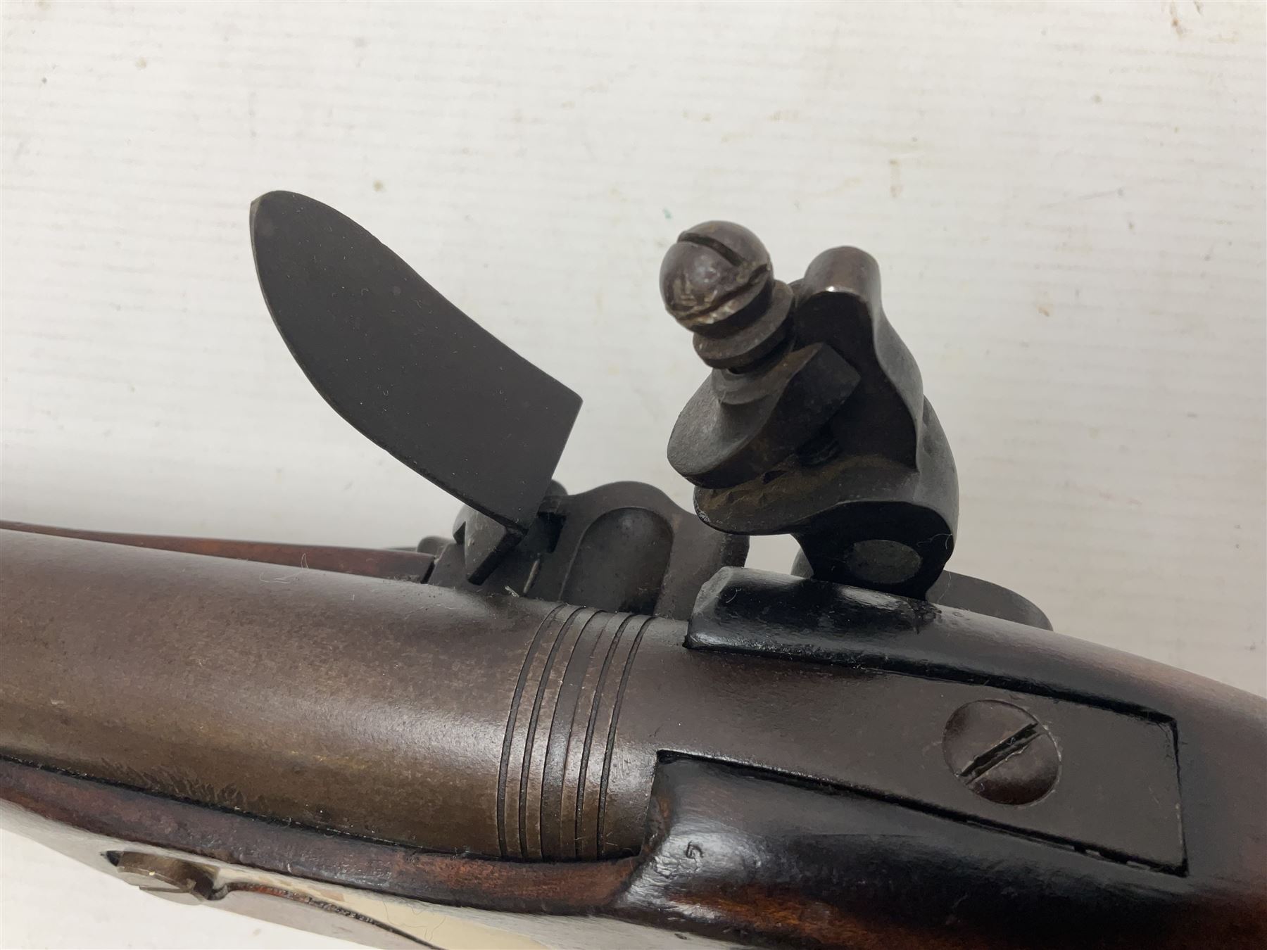 Modern non-firing reproduction Tower flintlock pistol marked with crowned GR and Tower to the lock, brass skull crusher butt and fittings L40cm overall; another Indian/Moorish reproduction flintlock pistol with mother-of-pearl inlay; and a modern die-cast replica Colt style revolver (3)