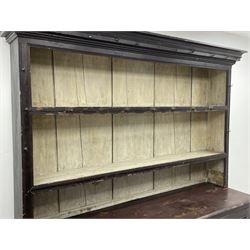Early 19th century scumbled pine dresser, the projecting cornice over two heights plate rack with moulded frame, the base with reeded canted corners fitted with three drawers and two panelled cupboards, panelled sides, moulded skirt base