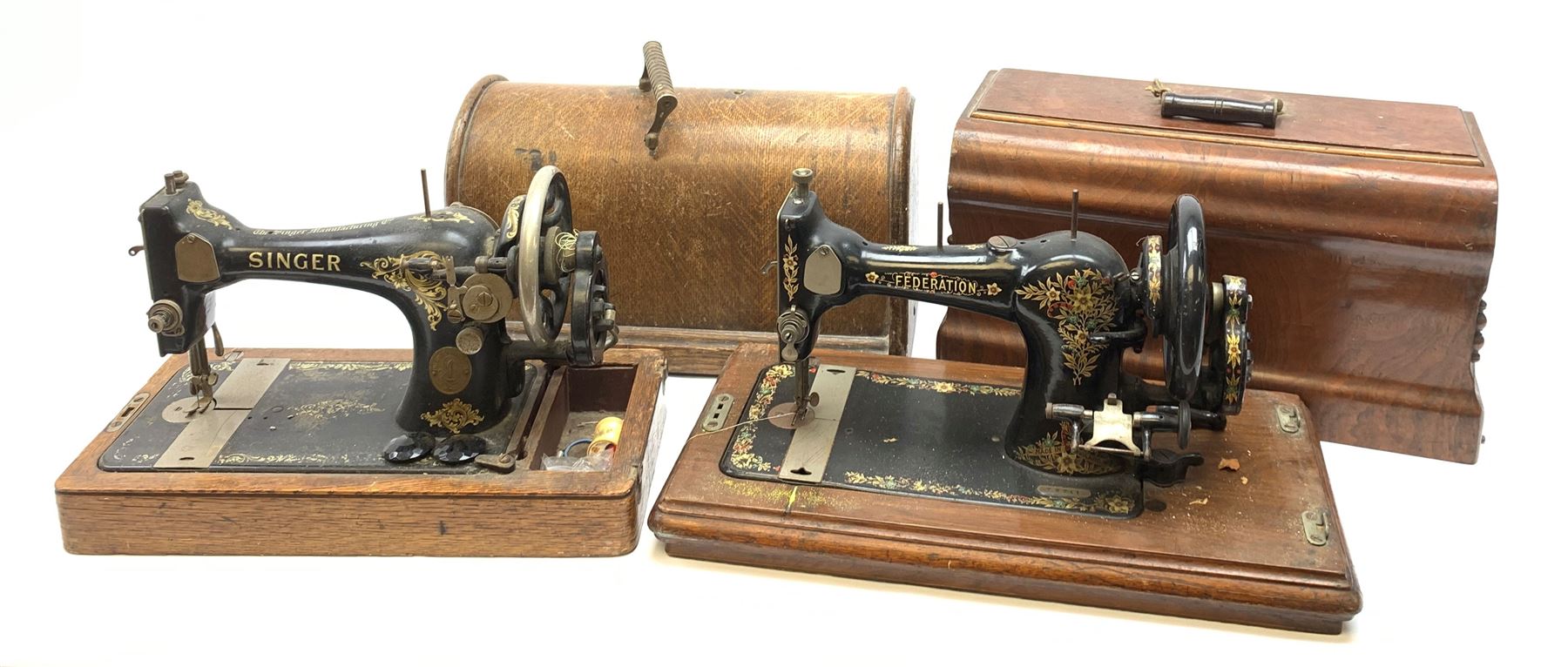 Two vintage sewing machines, the first marked Federation, in mahogany case, the second marked Singer, in oak case. 