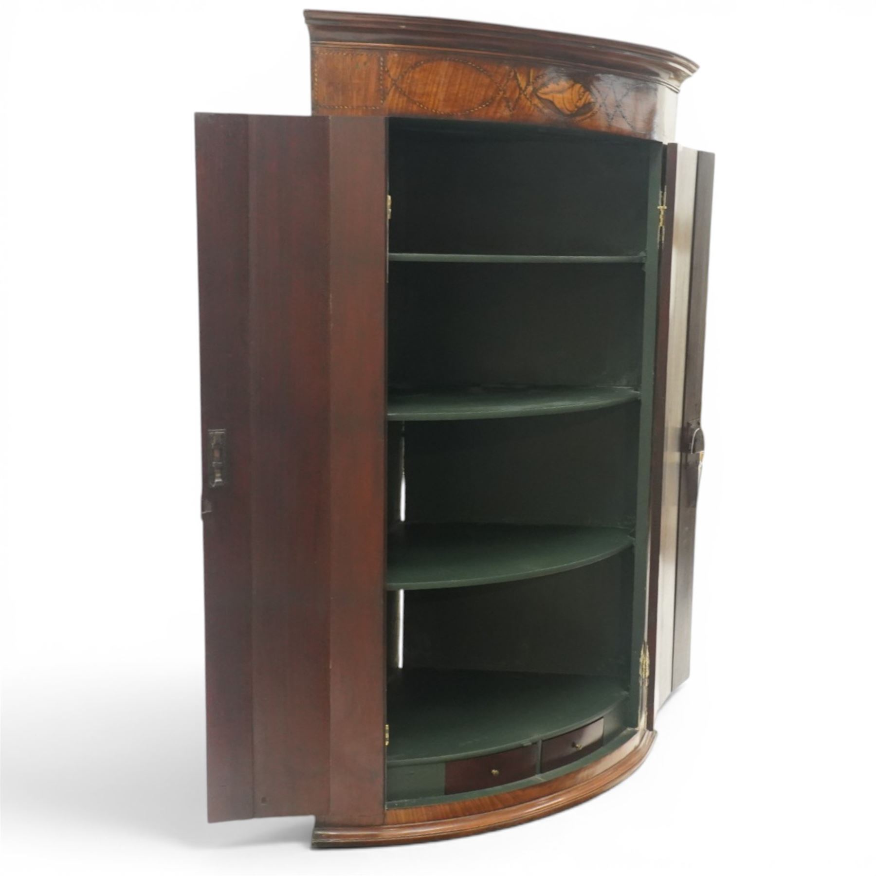 Georgian inlaid walnut cylindrical corner cupboard, projecting cornice over a banded frieze with inlaid shell motif, enclosing three shelves with two spice drawers fitted to base