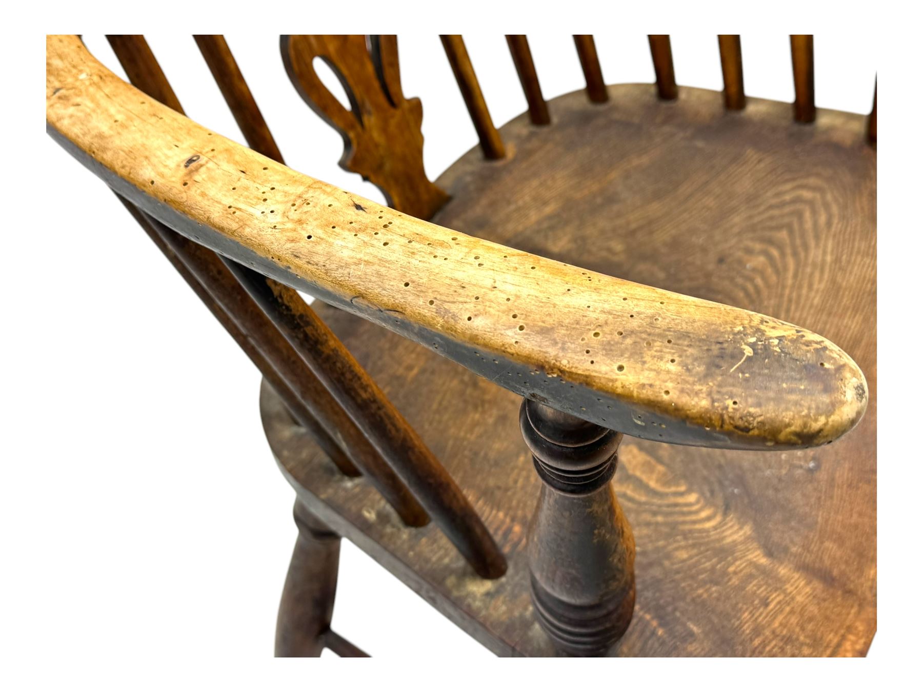 19th century provincial elm and beech Windsor armchair, shaped cresting rail over stick back with pierced and shaped splat, the dished seat on turned supports united by turned stretchers 