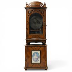 Late 19th century coin operated floor standing Polyphon, the shaped cornice marked 'Polyphon' with eleven 50cm discs in a walnut case with glazed upper section, the coin slot marked '1 Penny', the lower section with fall front for disc storage and inset with a portrait print and on compressed bun feet H230cm x W76cm x D46cm with a number of old pennies