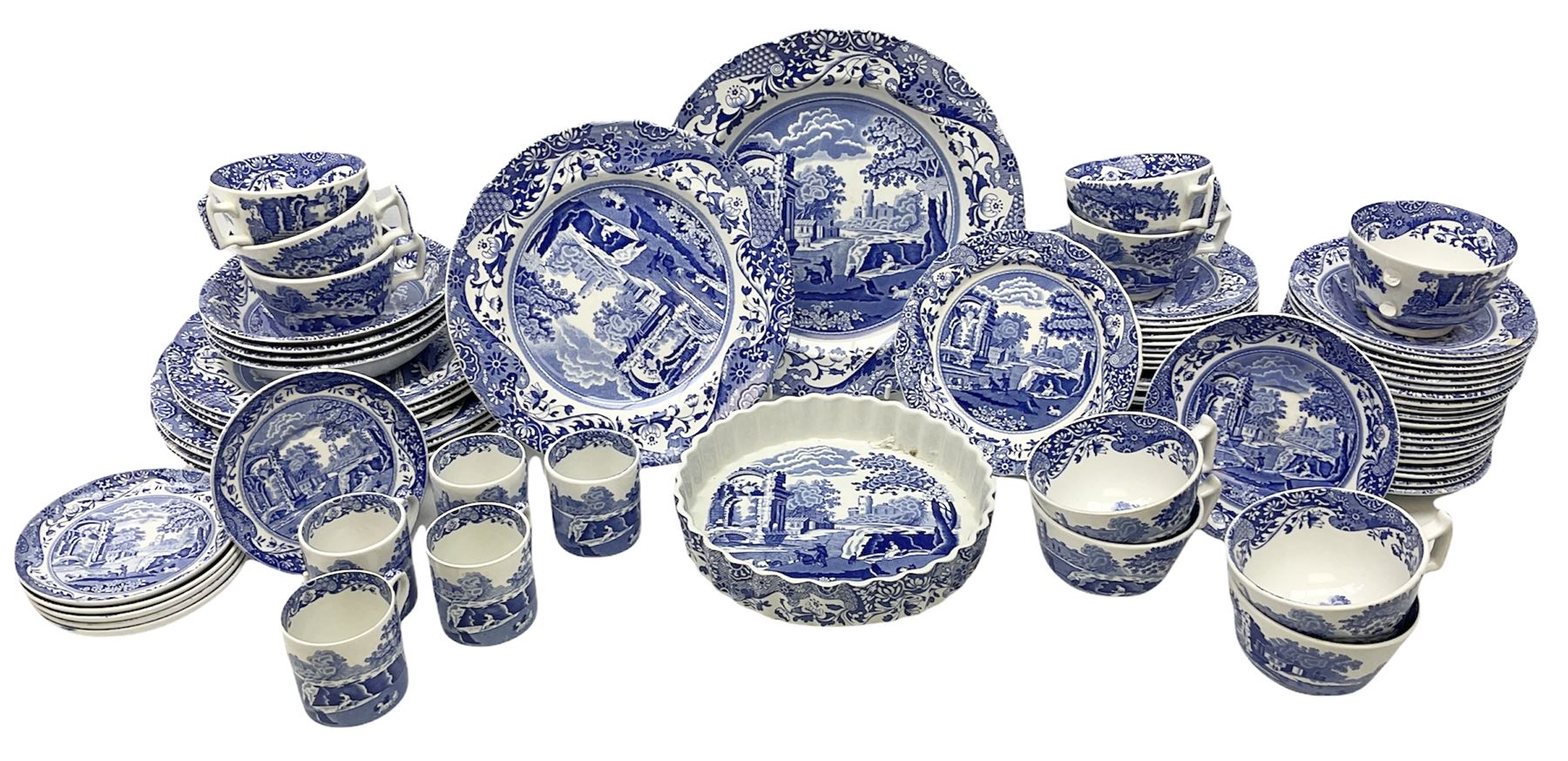 Spode blue and white Italian pattern dinner and tea wares, comprising five dinner plates, four side plates, seventeen side plates, four bowls, ten tea cups and twenty one saucers, five coffee cans and six saucers, and a flan dish, with blue and black printed marks beneath 