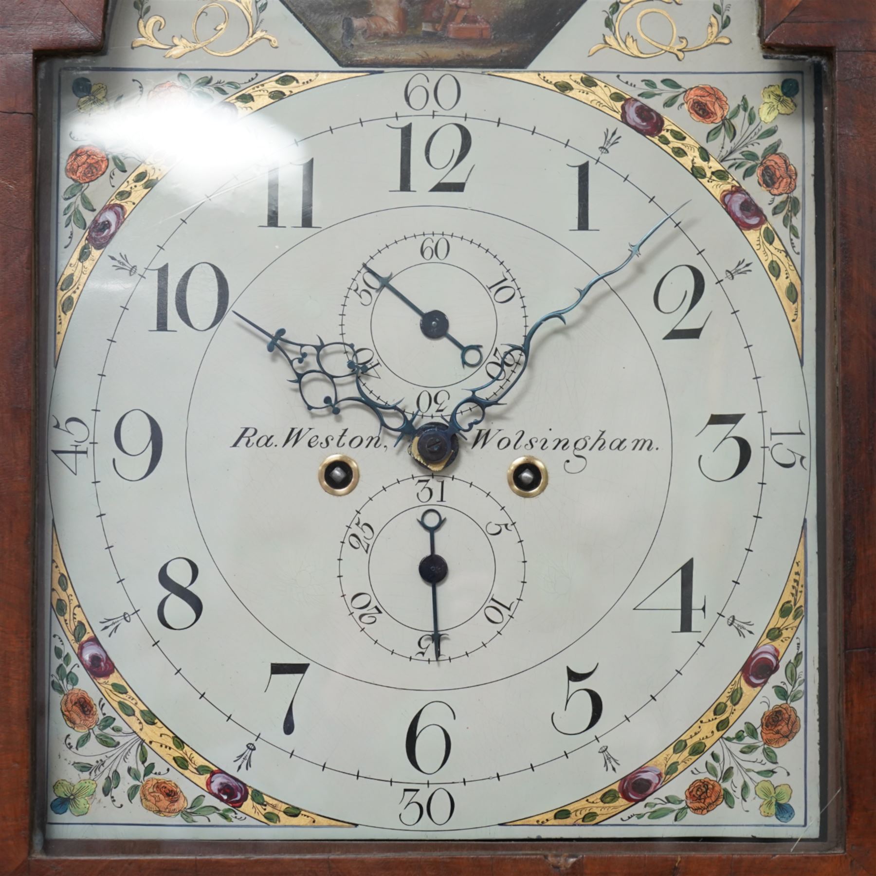 Ralph Weston (III) of Wolsingham (Co Durham) - 30-hour oak and mahogany longcase clock c1815-17, With a swan necked pediment, brass parterre and central spire finial, break arch hood door beneath flanked by reeded pilasters with brass capitals, trunk with recessed reeded pilasters and a crossbanded door with a concave top, square plinth on bracket feet, painted dial with floral depiction to the spandrels and a depiction of a boy attempting to catch birds in the arch, with makers name, Roman numerals, five minute Arabic's, minute track and matching steel hands, with dummy seconds and calendar dials and dummy winding arbors, dial pinned via a cast falseplate by Whittaker & Shreeve to a countwheel striking chain driven movement striking the hours on a bell. With weight and pendulum.
Notes.
The Weston family were a prodigious three generation family of 18th and 19th century Wolsingham clockmakers, all christened Ralph. The maker of this clock Ralph (III) frequently made 30hr clocks such as this possessing features normally found on  8-day clock dials.
Both the clockmaker, clock and dial were the subject of a comprehensive five part article in CLOCKS magazine published between  Nov 2012 and March 2013. The dial of the clock being of particular interest, manufactured by the Haifax firm of Shreve and Whittaker between 1815-17 . 
William Shreeve, a highly respected and competent dial painter went into a short-lived partnership with William Whittaker in 1815, however in 1817 Shreeve died in a tragic accident whereby he was burnt to death whilst preparing some of his own paints and varnishes. 

