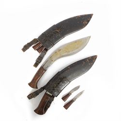 Two WWII Kukri knives, wooden grip with brass cap to pommel, single edged curved blade, wi...