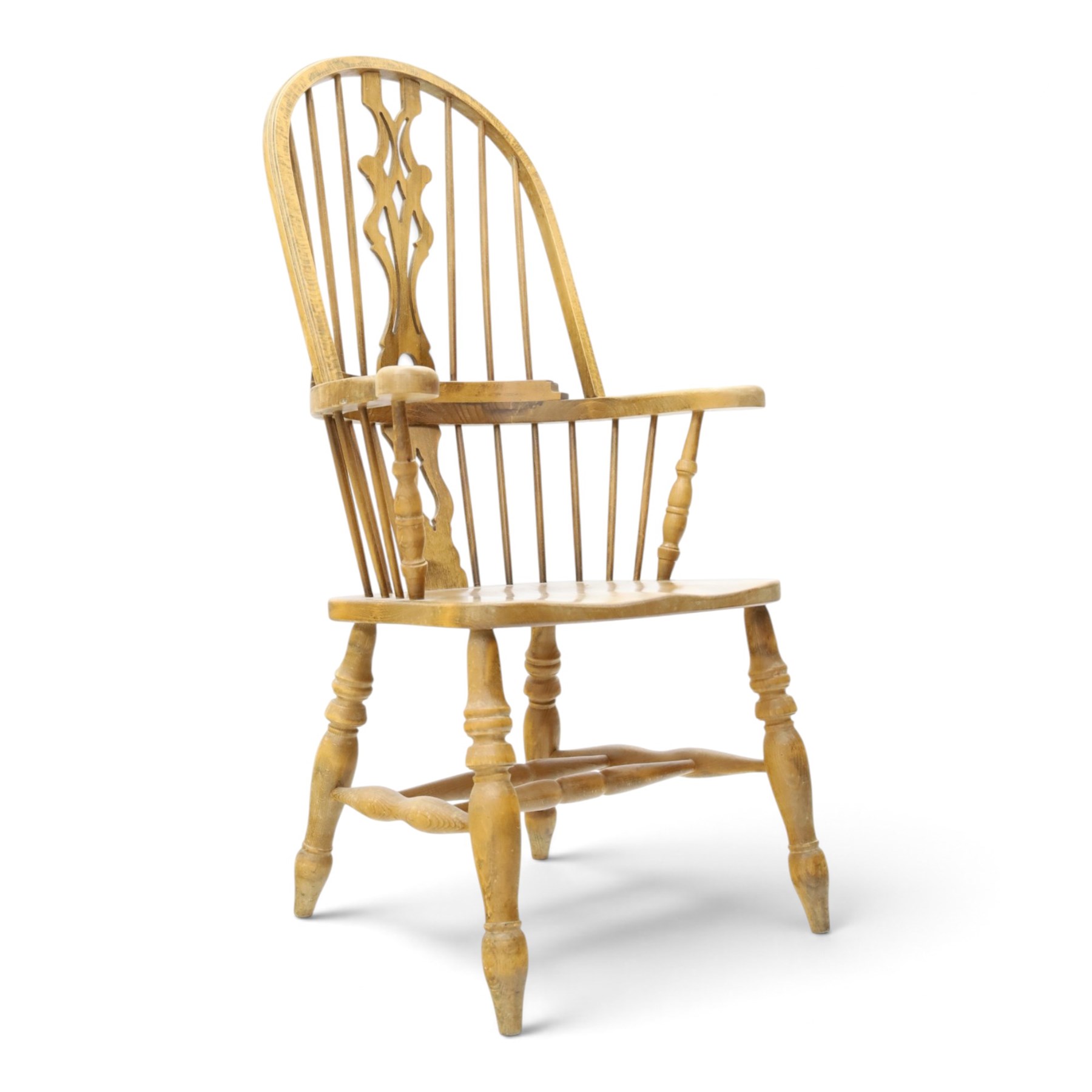 Traditional elm Windsor armchair, hooped spindle back with pierced splat, shaped elm seat, on turned supports united by double H stretcher, turned supports