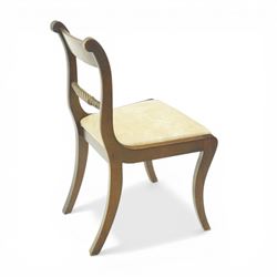 Late 20th century Regency style mahogany dining chairs, set of four, bar backs with figured veneered top rails and turned spindle stretchers, drop-in seats upholstered in beige leather, on moulded sabre supports