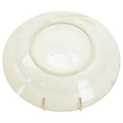 Two Japanese Edo period Ko Imari blue and white porcelain chargers, each decorated in the Kraak style with urns issuing peonies, pine and prunus, within panelled borders containing flowers, tress and precious objects, each approximately D 31.5cm