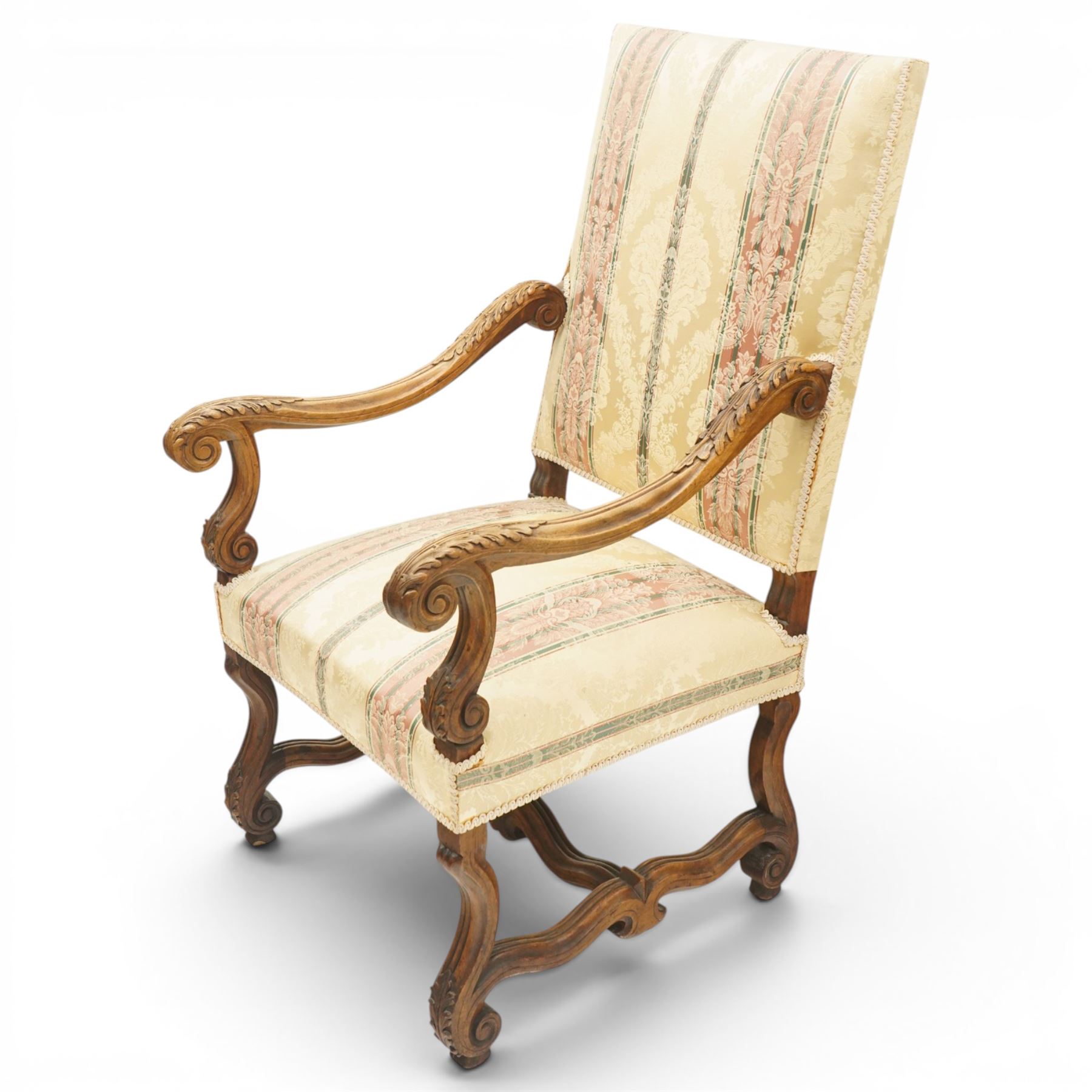 Pair of French Louis XIV design carved walnut open throne armchairs, high back and sprung seat upholstered in foliate damask fabric, acanthus carved scroll form arms over reeded and scrolled supports united by shaped stretcher