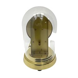  A late 20th century -  German Kieninger & Obergfell, “Kundo” battery operated
mantle clock under an acrylic shade, with an electrically operated solenoid pendulum housed on a circular brass base, skeleton movement with visible motion work through a painted 4-1/2” open chapter ring, with pierced steel hands, Roman numerals and minute track.