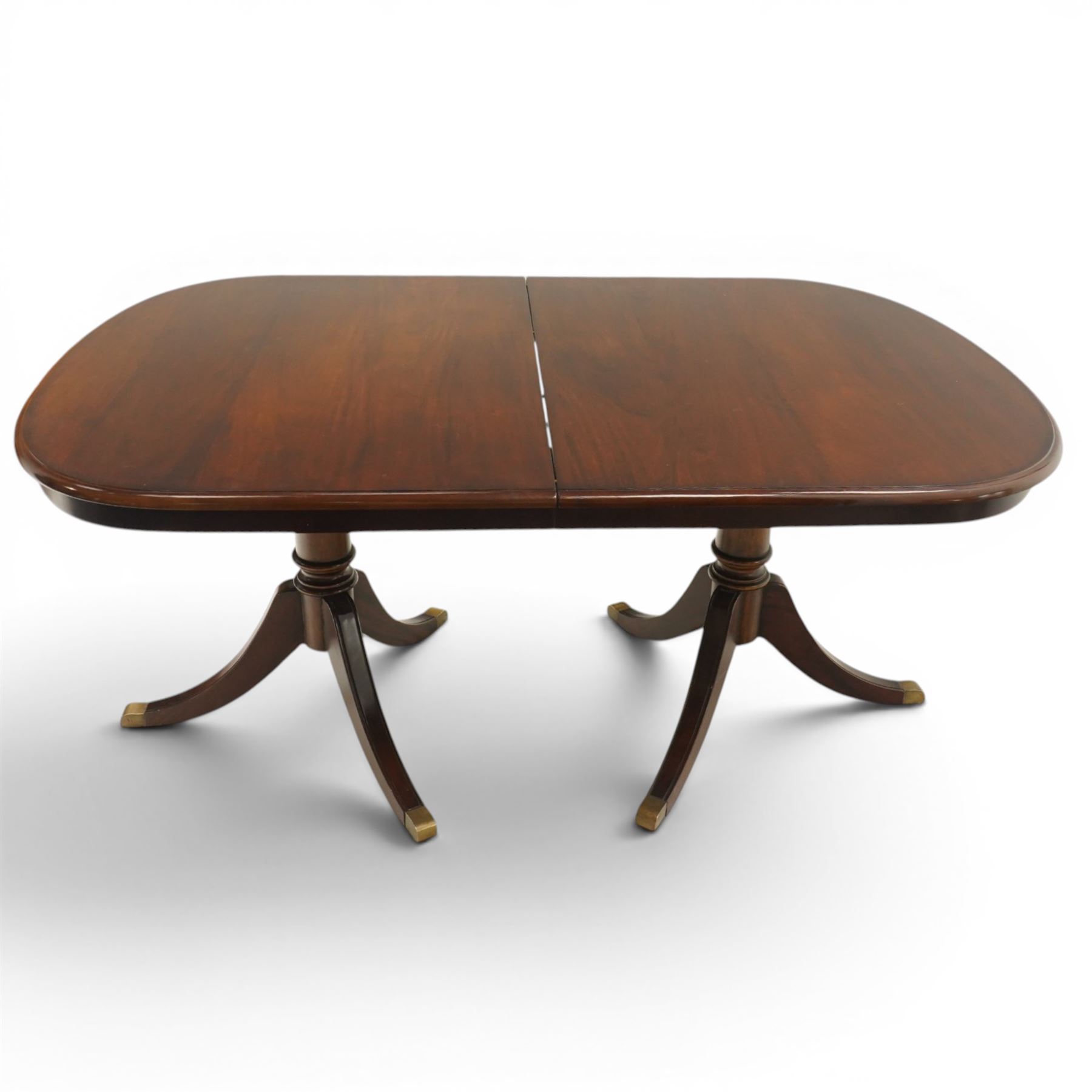 Georgian design mahogany twin pedestal extending dining table, rectangular rounded top on twin tripod pedestals with splayed supports, with additional leaf (W170cm D115cm H77cm); with set six (4+2) matching mahogany framed cameo-back dining chairs, upholstered in pale yellow lozenge patterned fabric (W57cm H94cm)