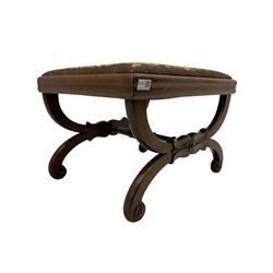 Early Victorian walnut curved x-frame stool, turned stretcher, carved with flower heads, upholstered drop in cushion with needle work cover
