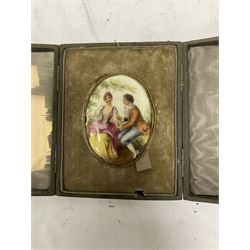 Early 20th century gilded metal brooch, with inset painted panel depicting seated courting couple, impressed 7778 60 to reverse, lacking backing/pin, with case, L6cm