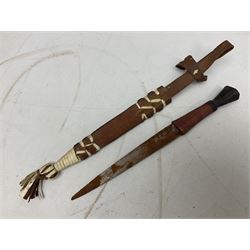 Indian kukri with 29cm curving steel blade and nickel mounted horn grip; in leather covered scabbard with one skinning knife L42cm overall; Hitler Youth knife with scabbard in relic condition; and three African graduated knives each with crudely carved wooden grips and painted leather covered scabbards (5)