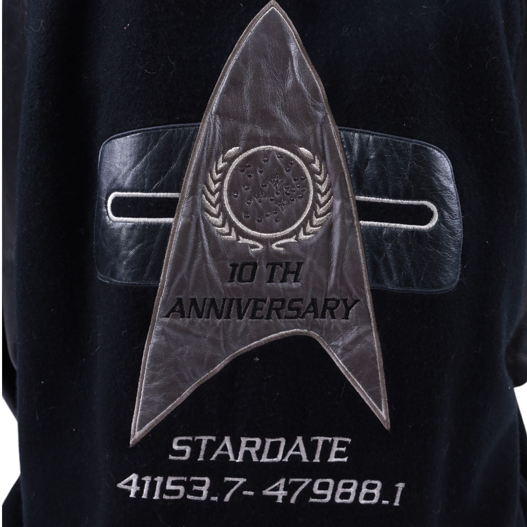 Star Trek The Next Generation 10th anniversary jacket, leather sleeves and collar with embroidered decoration throughout, including 10th anniversary emblem to back, 'Star Trek The Next Generation' to collar, 'Paramount Pictures Stages 8,9 & 16' to front and seven character names to interior, in size XXXXL, purchased in 1990s from Star Trek Experience Las Vegas