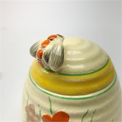 A Clarice Cliff Newport Pottery honey pot, modelled in the form of a beehive and decorated in the Crocus pattern, H10cm.