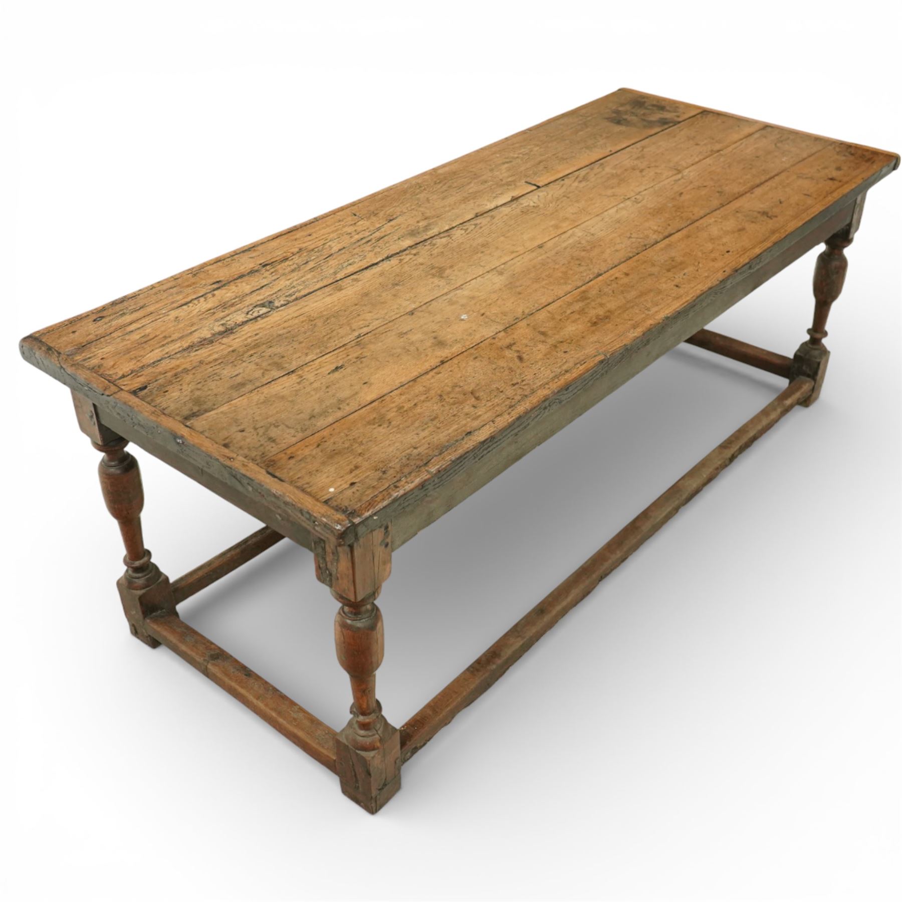 Late 17th to early 18th century oak joint refectory dining table, rectangular four plank top, raised on turned baluster legs, united by chamfered stretchers