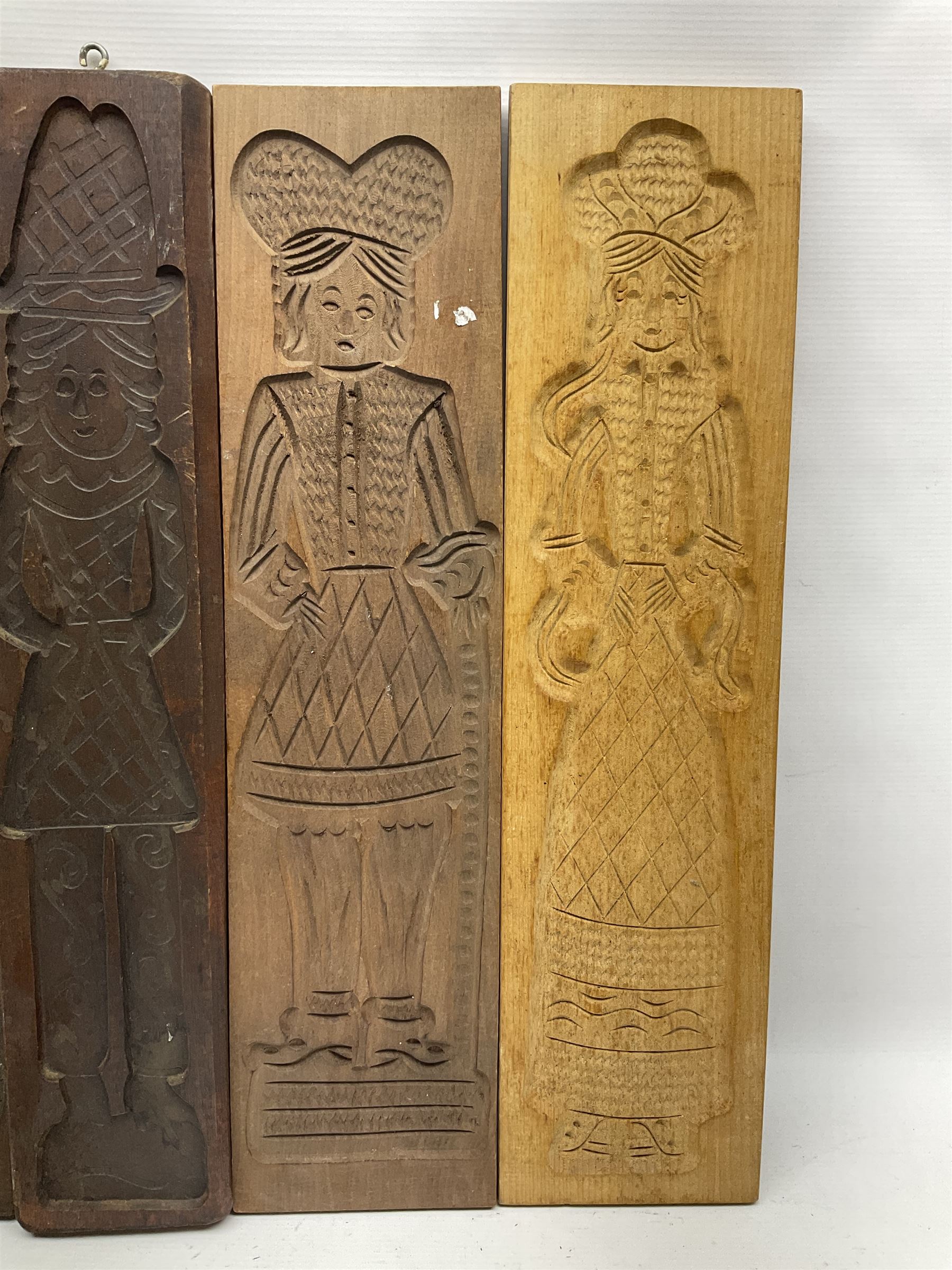 Eight 20th century hardwood Dutch folk art Speculaasplank or biscuit moulds, most examples typically carved with figures in traditional dress, tallest H60cm