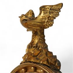 Regency period eagle mounted giltwood convex mirror, surmounted by a finely carved giltwood eagle standing on rocks above the circular mirror with the original mirror plate and surrounded by a fluted ebonized slip and the convex frame with gilt ball decorations, the back with label for ‘T.G. Woof Ltd, manufacturing cabinet makers, Devonshire Street, Sheffield