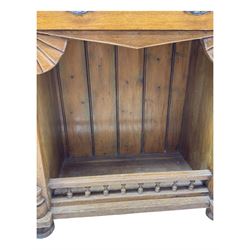 Late 19th century pine dresser, the projecting cornice with dentil and spindle moulded frieze above a three-tier plate shelves, flanked by glazed doors, the base fitted with three frieze drawers over arched apron and carved floral panelled cupboard doors, raised on turned feet