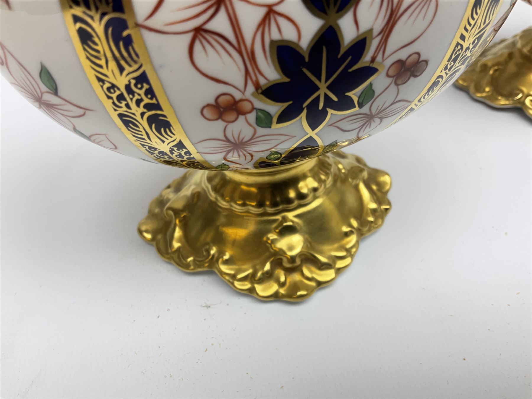 Pair of mid 20th century Royal Crown Derby Imari 1128 pattern Kedleston ewers, each with gilt scroll handle and neck, upon a gilt quatrefoil foot, each with printed marks beneath, H25.5cm
