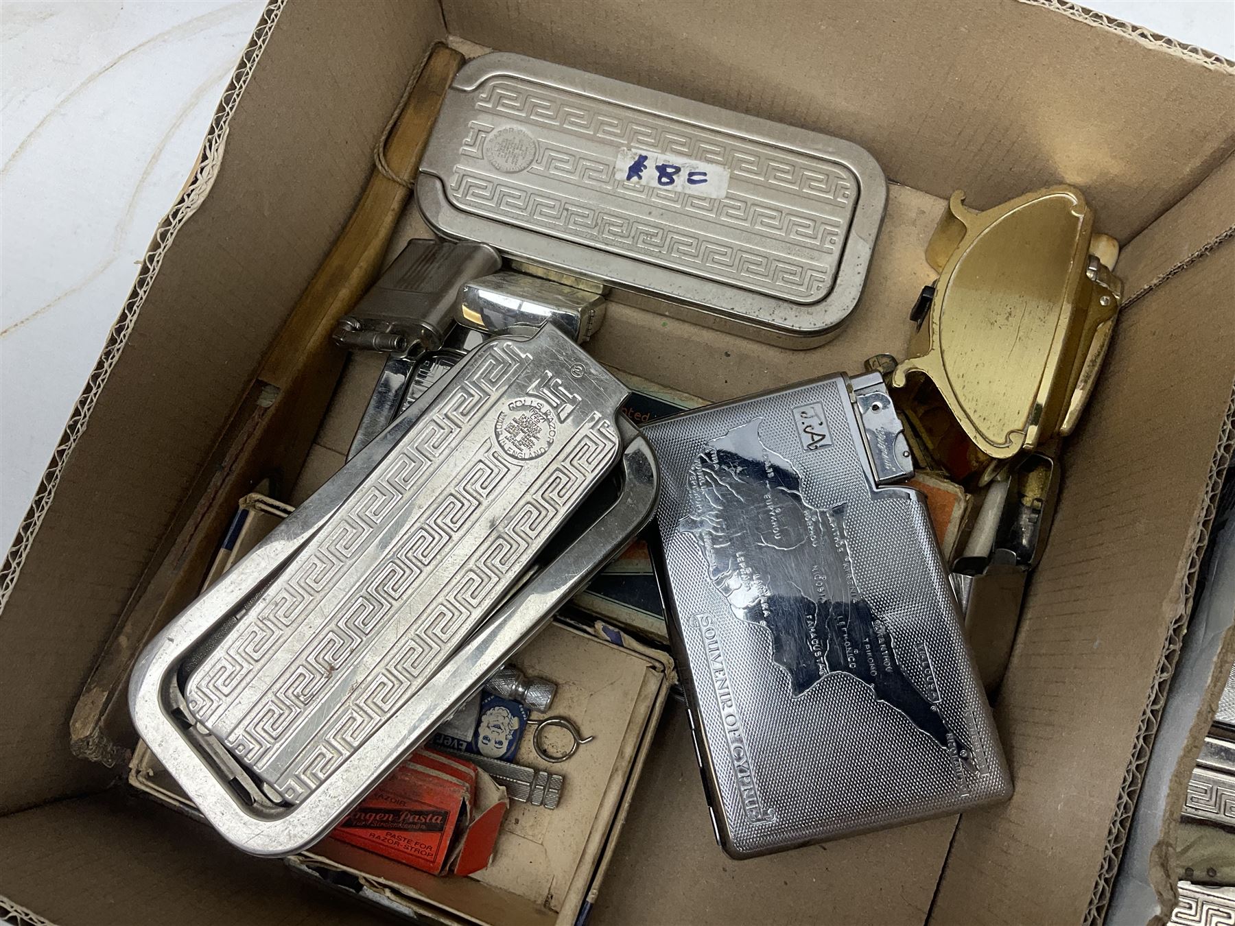 Collection of various razors and smoking items to include Ronson brass table lighter, Rolls Razor, Seigneur case with lighter, etc