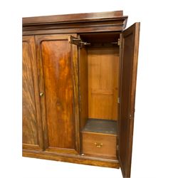 Victorian figured mahogany linen-press wardrobe, projecting cornice over triple panelled doors, left-hand side fitted with lien slides, two short and two long drawers, the right-hand door enclosing hanging space, plinth base