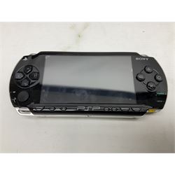 Sony PlayStation 3 60GB console with one PS3 controller, two PS2 controllers, BD remote control, PSP handheld gaming console with case, GAMEware PSP essentials pack, and a selection of PS2, PS3 and PSP games in original cases with instruction booklets 