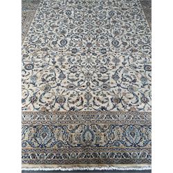Fine Persian Kashan carpet, ivory ground with overall interlacing and scrolling foliate design, decorated all over with stylised flower heads, repeating guarded border