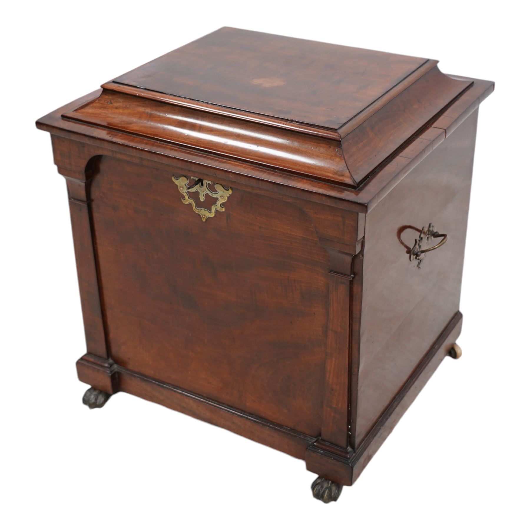 William IV mahogany cellarette, the rectangular hinged sarcophagus top enclosing bottle dividers and metal liner, the front applied with flanking flat pilasters, fitted with pressed brass handle plates escutcheon, lower moulded edge over brass hairy paw feet