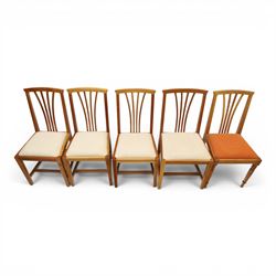 Knightman - set of nine cherrywood dining chairs, with fan splat backs and upholstered seats, raised on square legs joined by stretchers, comprising chairs of slight differing widths and one chair with turned front legs and orange upholstery and no Knight carving, the rest with recessed carved knight trademark, by Horace Knight of Old Mill Furniture, Balk near Thirsk 