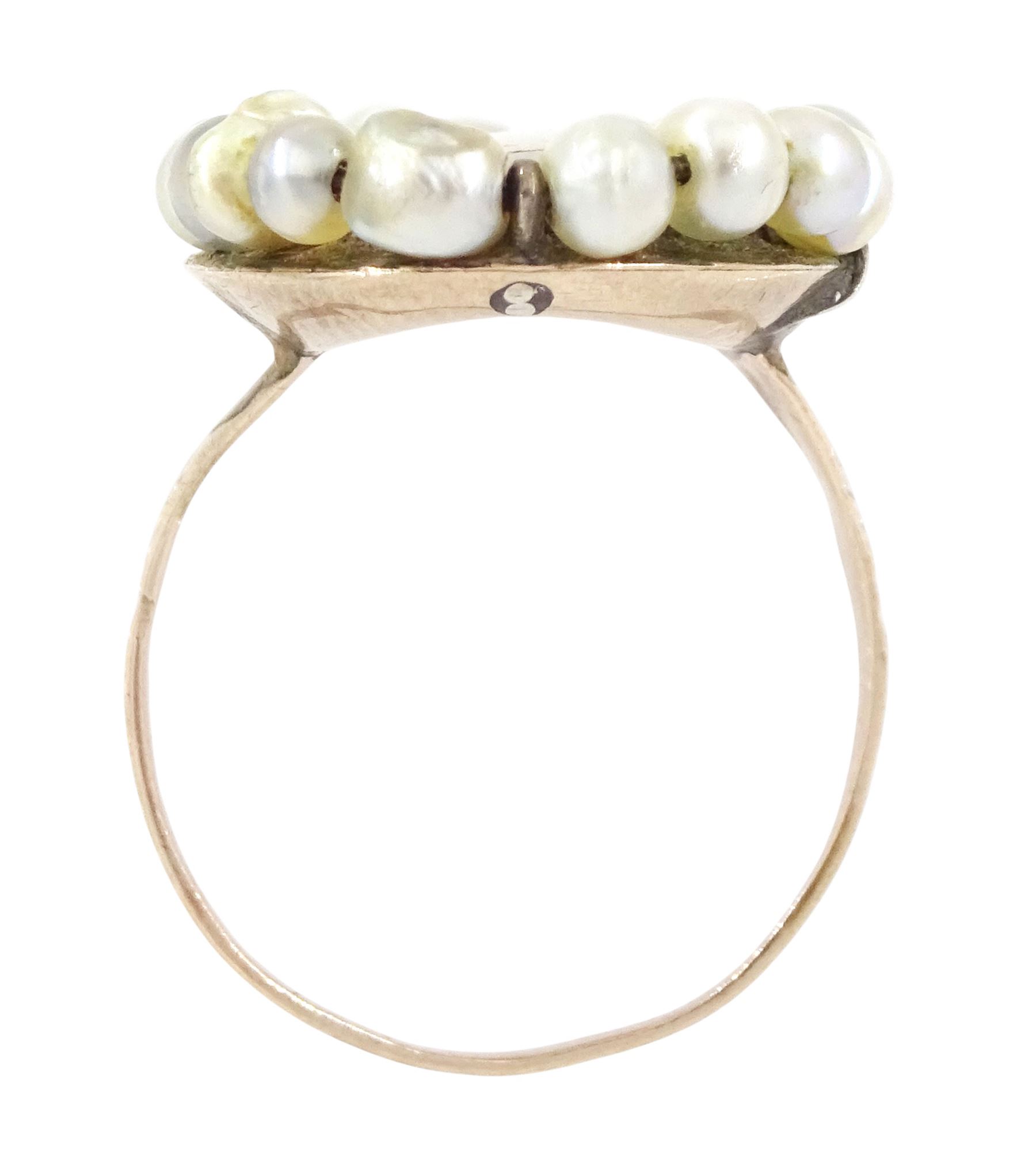 19th century portrait ring, set with an oval miniature of a woman wearing a pink dress on ivory, under a glazed panel, with threaded pearl surround and engraved shoulders. This lot has been registered for sale under Section 10 of the APHA Ivory Act