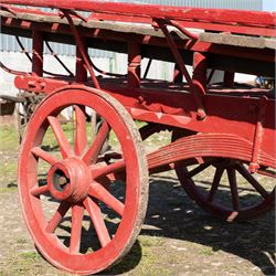 Costermonger’s Cart

A painted costermonger’s cart with red timber frame, slatted deck and wooden spoked wheels. The cart has long hand rails, raised side rails and turned supports, with incised inscriptions to the frame, including “Meyers Bros”. The form is consistent with a hand drawn market cart, used for carrying and displaying produce or goods.

Features:
Red painted timber frame
Slatted wooden deck
Wooden spoked wheels
Long hand rails
Raised side rails
Turned timber supports
Incised inscriptions to the frame
“Meyers Bros” inscription visible
Traditional market cart form

Dimensions:
Length: 240 cm (body approximately 210 cm)
Width: 102 cm
Height: 92 cm

Wheel diameter: 67 cm