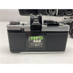 Four Olympus camera bodies, including Olympus OM10, serial no 20744269, with 'Olympus OM-System Zuiko Auto-S 50mm 1:1.8' lens serial no 3633644, Olympus OM-2 camera body serial no 460280 with 'Olympus OM-System G.Zuiko Auto-s 1:1.4 f=50mm' lens, serial no 729750, etc 