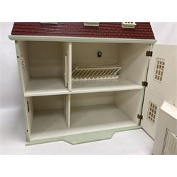 Wooden double-fronted, three-storey dolls house, with pale green stucco finish and simulated tile roof, the central recessed front door with balustraded balcony above, single hinged front opening to reveal a five fully decorated rooms, together with a quantity of dolls house furniture and accessories W64cm, H75cm, D36cm