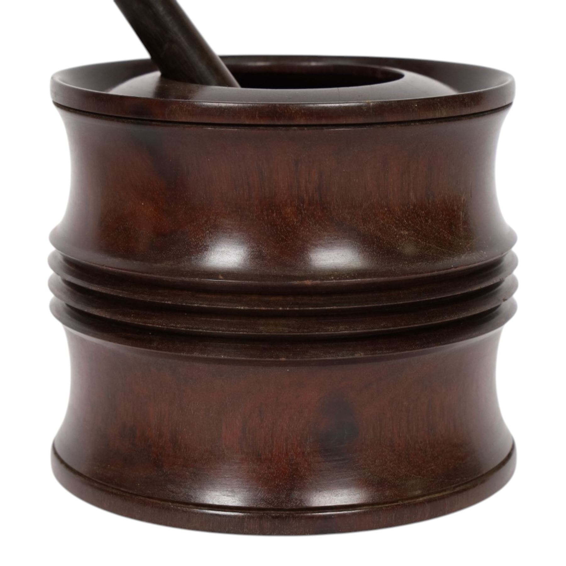 18th century lignum vitae captive mortar and pestle, the mortar of turned waisted form with central reeded girdle, and captive opening with rolled rim, H12.5cm D14cm, and pestle L17.5cm